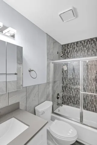 a bathroom with a toilet a sink and shower
