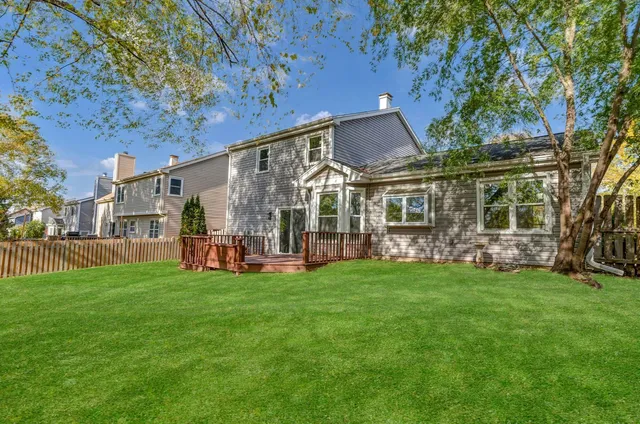 a view of a house with a yard and sitting area