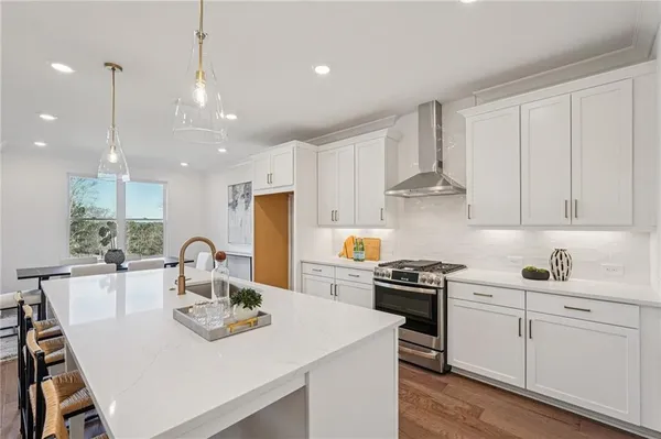 a kitchen with a table chairs stove and microwave
