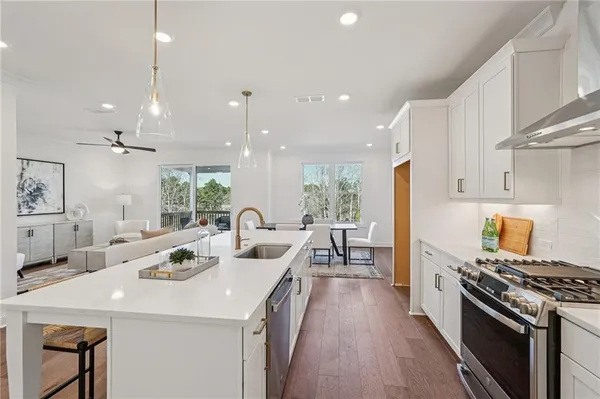 a kitchen with a sink and living room view