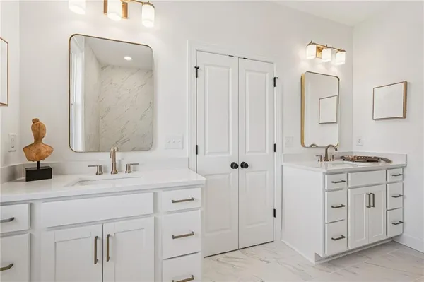 a bathroom with a double vanity sink mirror and double