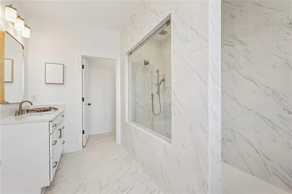 a bathroom with double vanity sink and a mirror