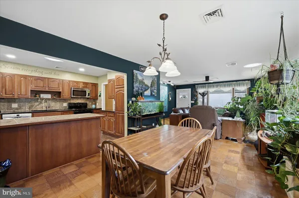 a kitchen with stainless steel appliances granite countertop a sink and wooden cabinets