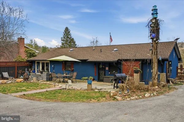 a front view of a building with dining table and chairs