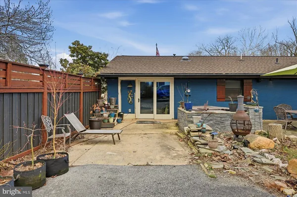 a spacious bedroom with a bed and a flat screen tv