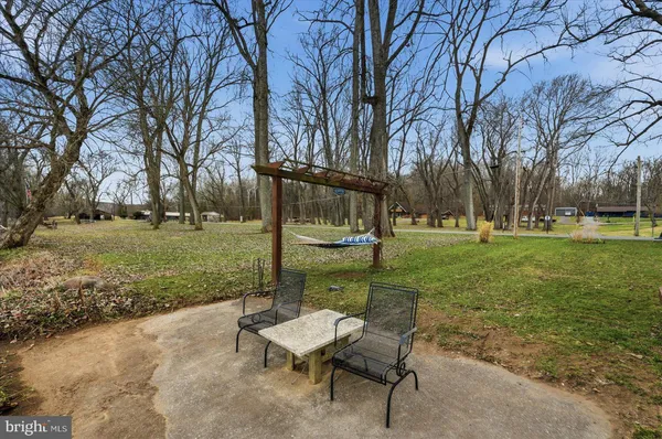 a view of a house with backyard and sitting area