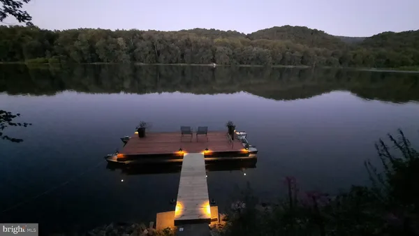 a living room with furniture ceiling fan and a window