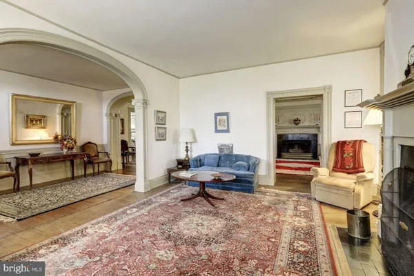 a large bedroom with bed and a fireplace
