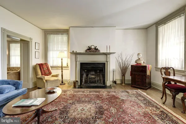 a spacious bedroom with a bed and a fireplace
