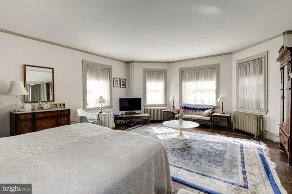 a living room with furniture a flat screen tv and kitchen view