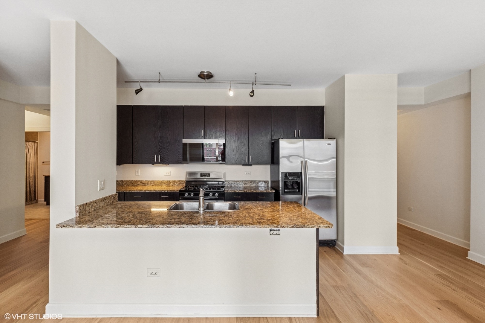 451 West Huron Street, Unit 910 Chicago, IL 60654 - Photo 13 of 27 a view of kitchen with stainless steel appliances granite countertop refrigerator sink and stove