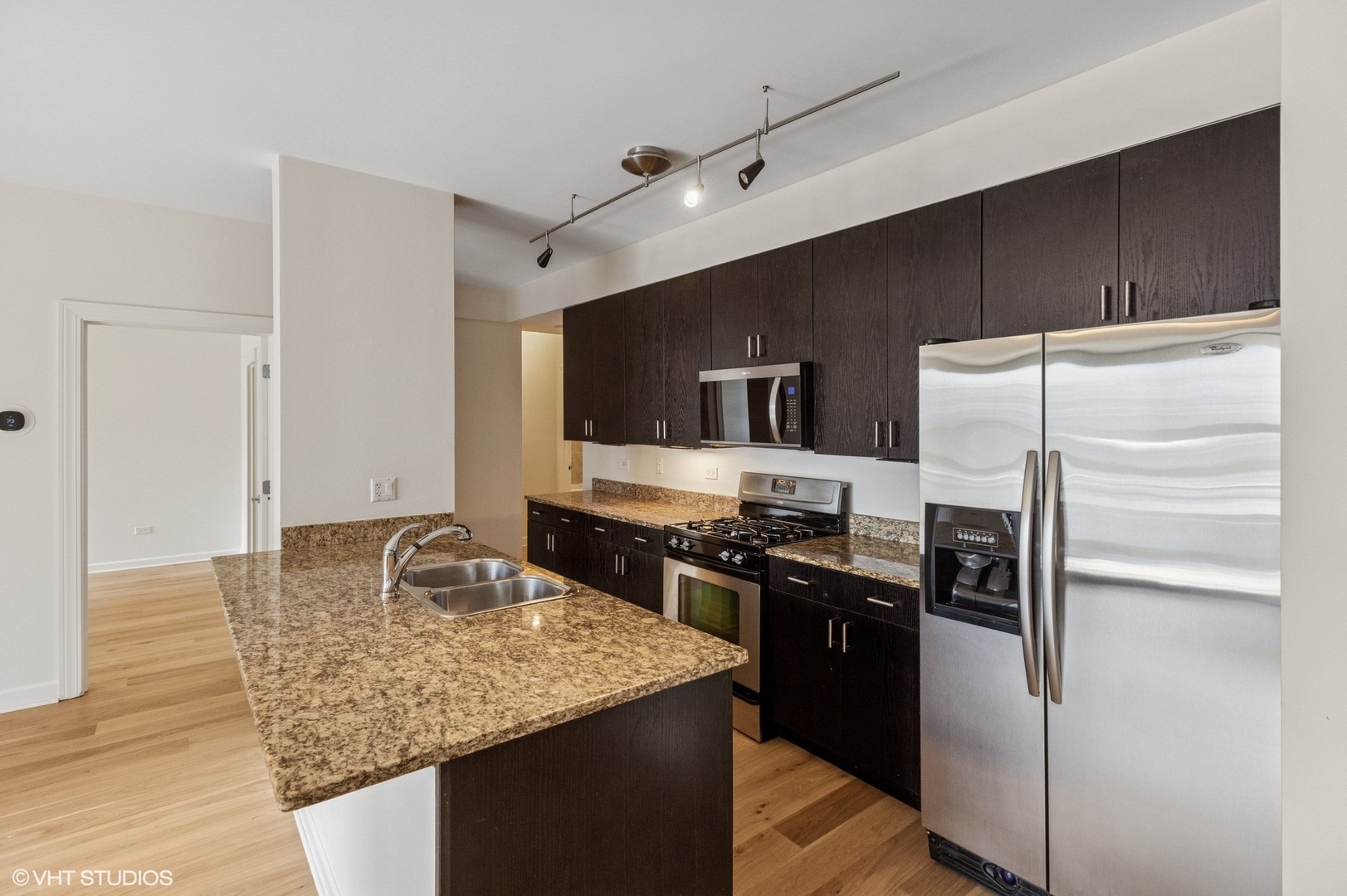 451 West Huron Street, Unit 910 Chicago, IL 60654 - Photo 14 of 27 a kitchen with stainless steel appliances granite countertop a sink stove and refrigerator