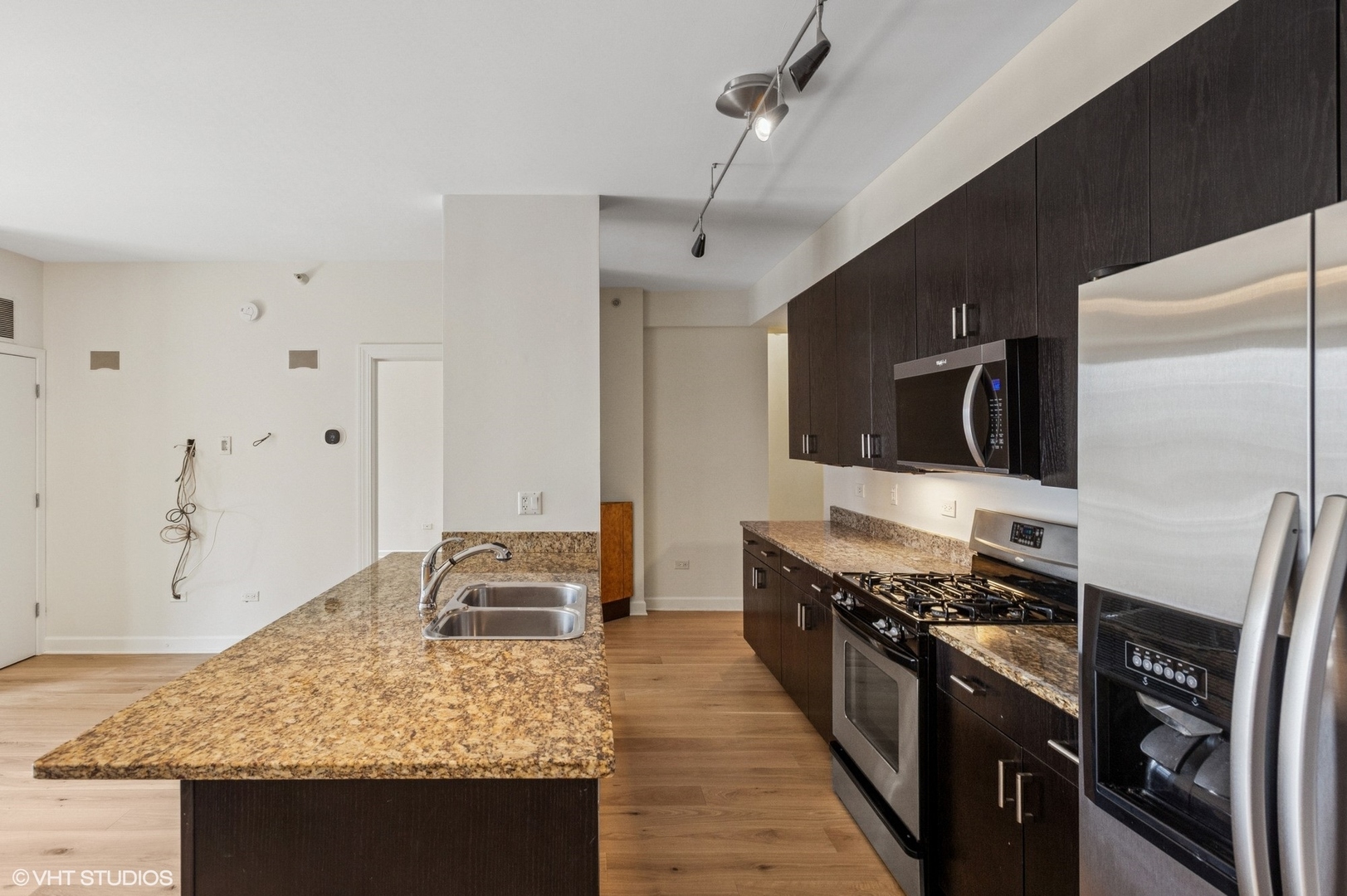 451 West Huron Street, Unit 910 Chicago, IL 60654 - Photo 15 of 27 a kitchen with stainless steel appliances granite countertop a stove and a refrigerator