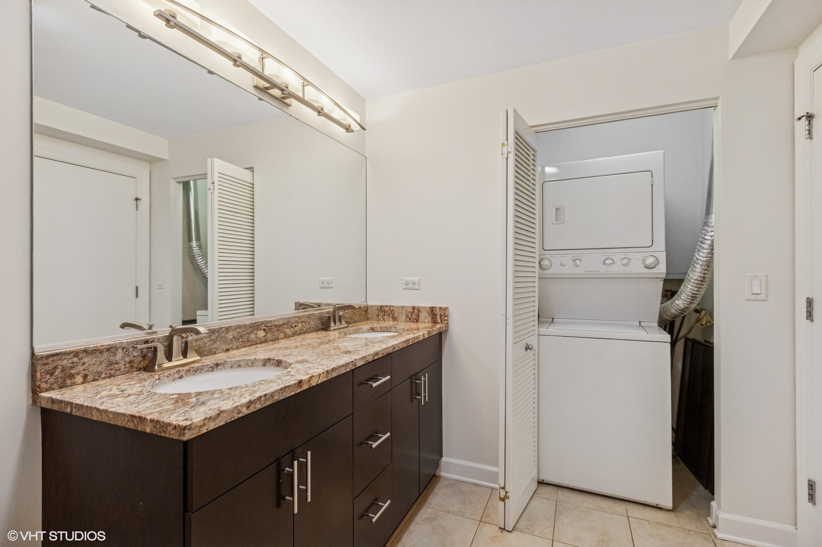 451 West Huron Street, Unit 910 Chicago, IL 60654 - Photo 19 of 27 a bathroom with a granite countertop sink and a mirror