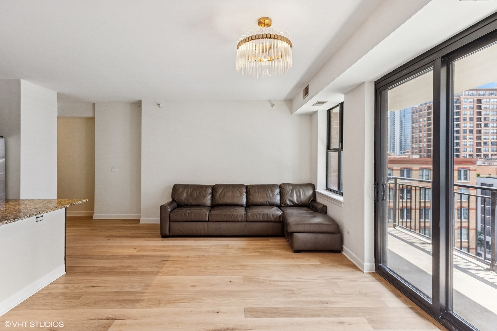 451 West Huron Street, Unit 910 Chicago, IL 60654 - Photo 21 of 27 a living room with furniture fireplace and a large window