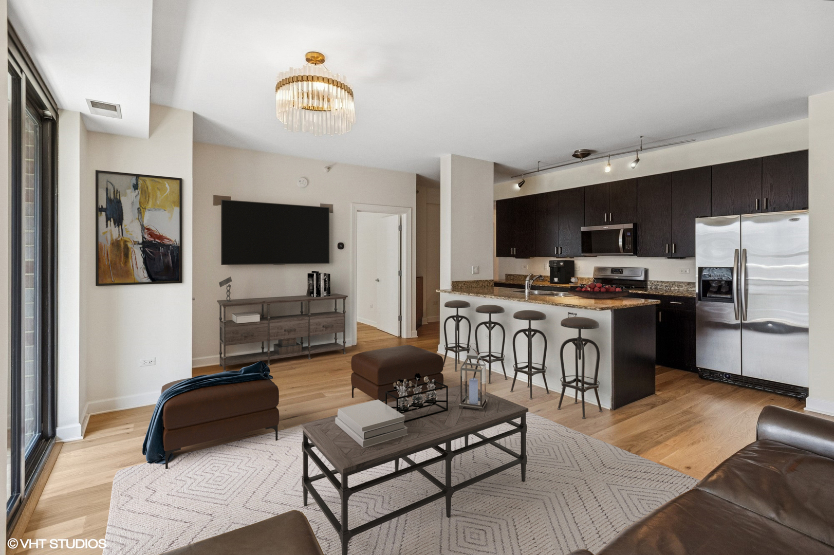 451 West Huron Street, Unit 910 Chicago, IL 60654 - Photo 4 of 27 a living room with furniture and a flat screen tv