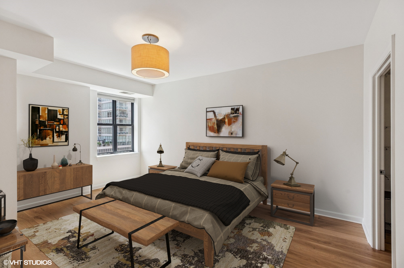 451 West Huron Street, Unit 910 Chicago, IL 60654 - Photo 6 of 27 a bedroom with a bed and wooden floor