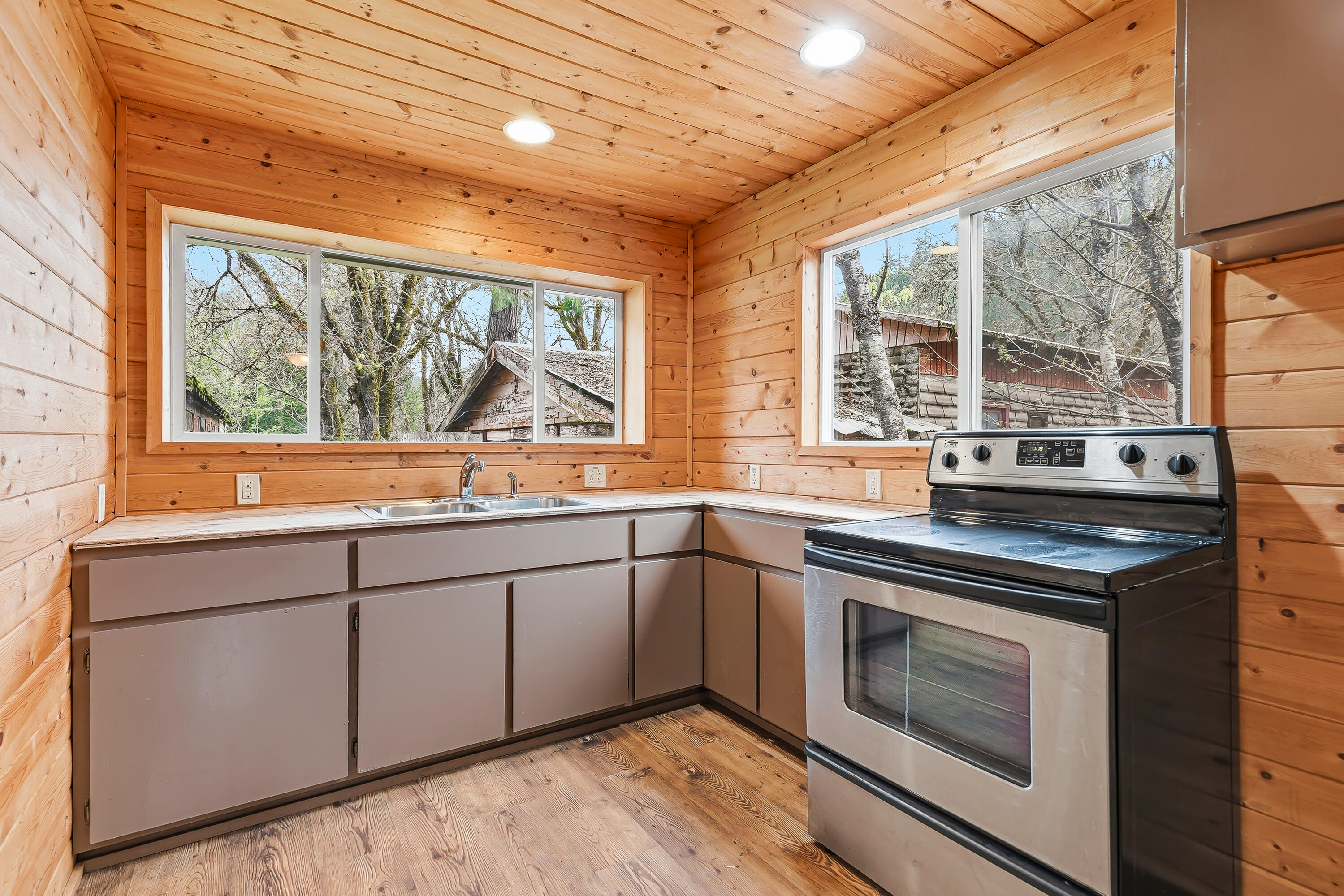 159 Bloom Road Wolf Creek, OR 97497 - Photo 11 of 38 a kitchen with stainless steel appliances granite countertop a stove and a sink