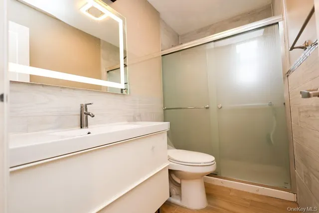 a bathroom with a sink a toilet and shower