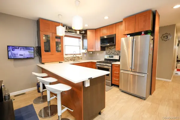 a kitchen with stainless steel appliances a refrigerator and a stove top oven