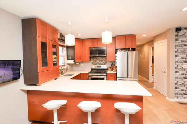 a kitchen with stainless steel appliances a sink and a table