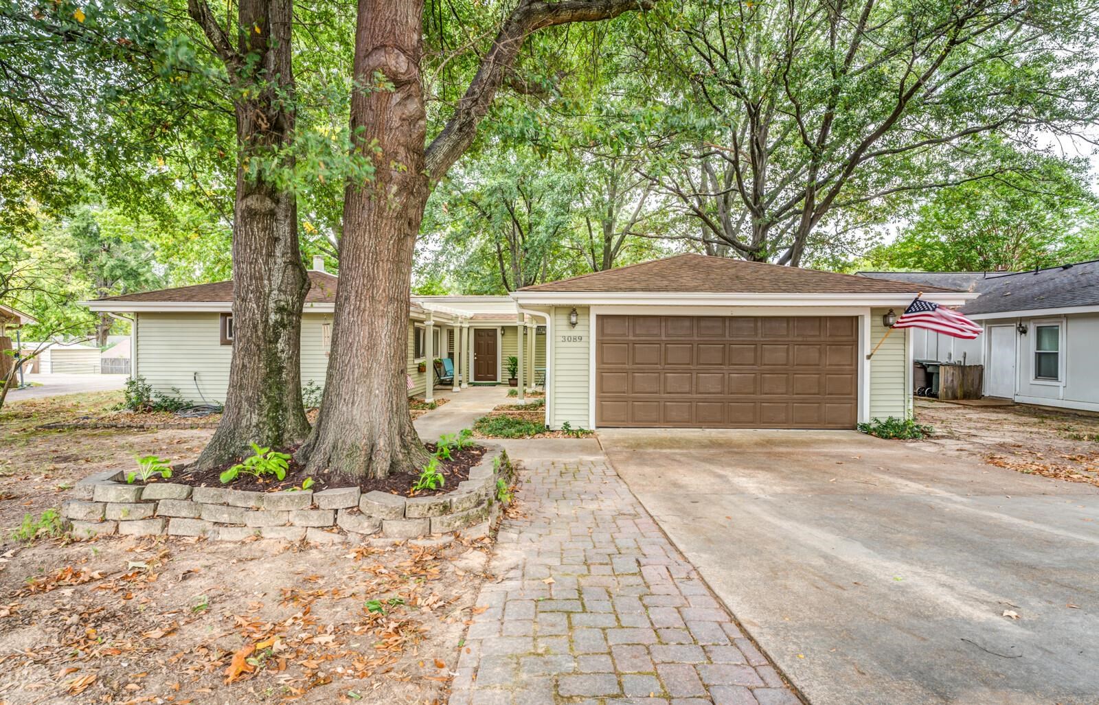 3089 Charles Bryan Road Bartlett, TN 38134 - Photo 1 of 28 a front view of a house with a yard and potted plants
