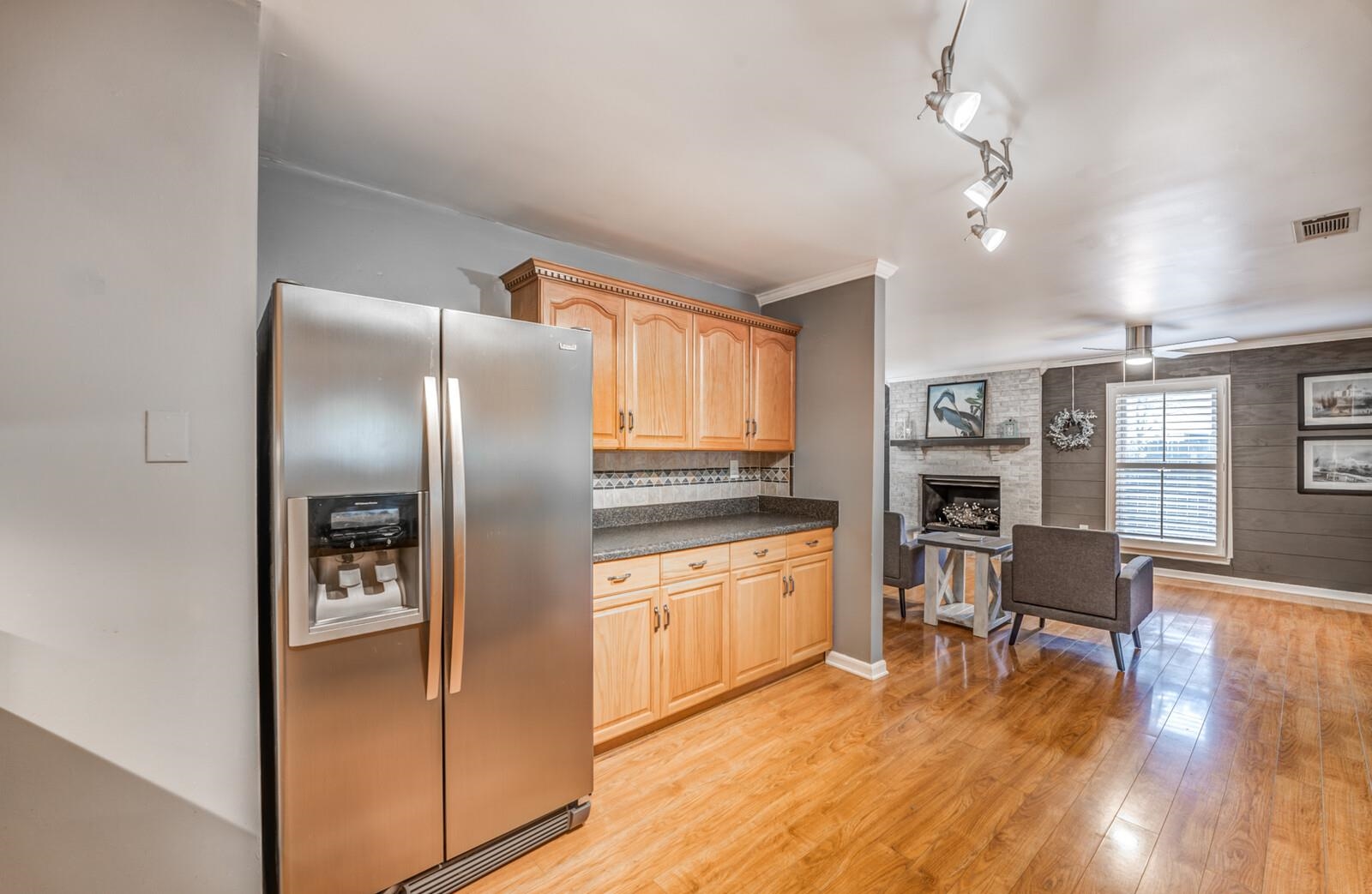 3089 Charles Bryan Road Bartlett, TN 38134 - Photo 9 of 28 a kitchen with stainless steel appliances granite countertop a refrigerator a stove and a wooden floors