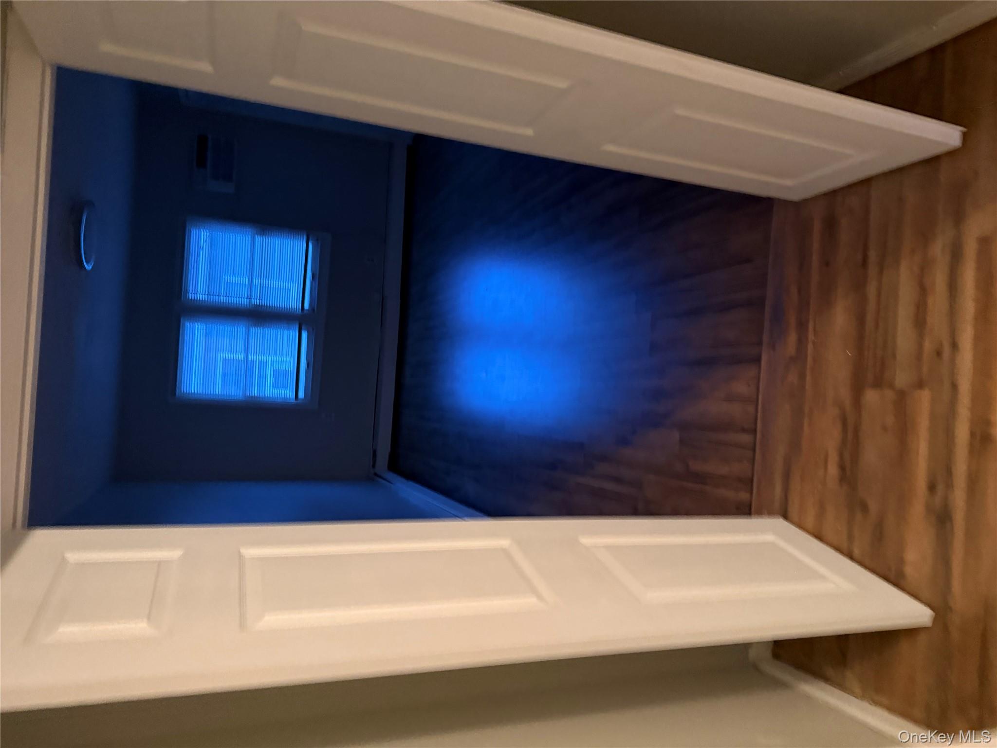 18 Leach Street Lynbrook, NY 11563 - Photo 14 of 17 a view of an empty room with wooden floor and a window