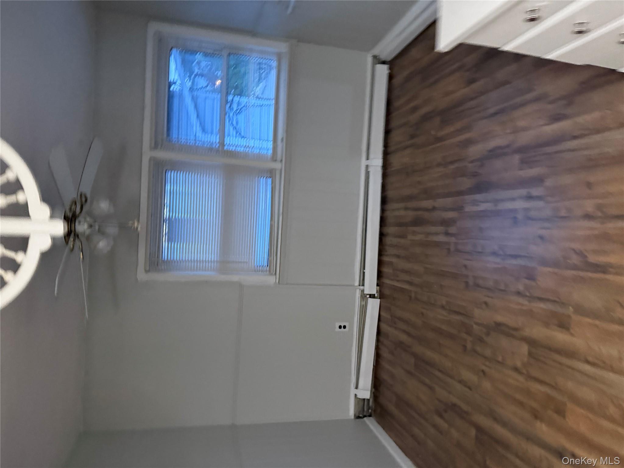 18 Leach Street Lynbrook, NY 11563 - Photo 16 of 17 a view of a room with wooden floor and white walls