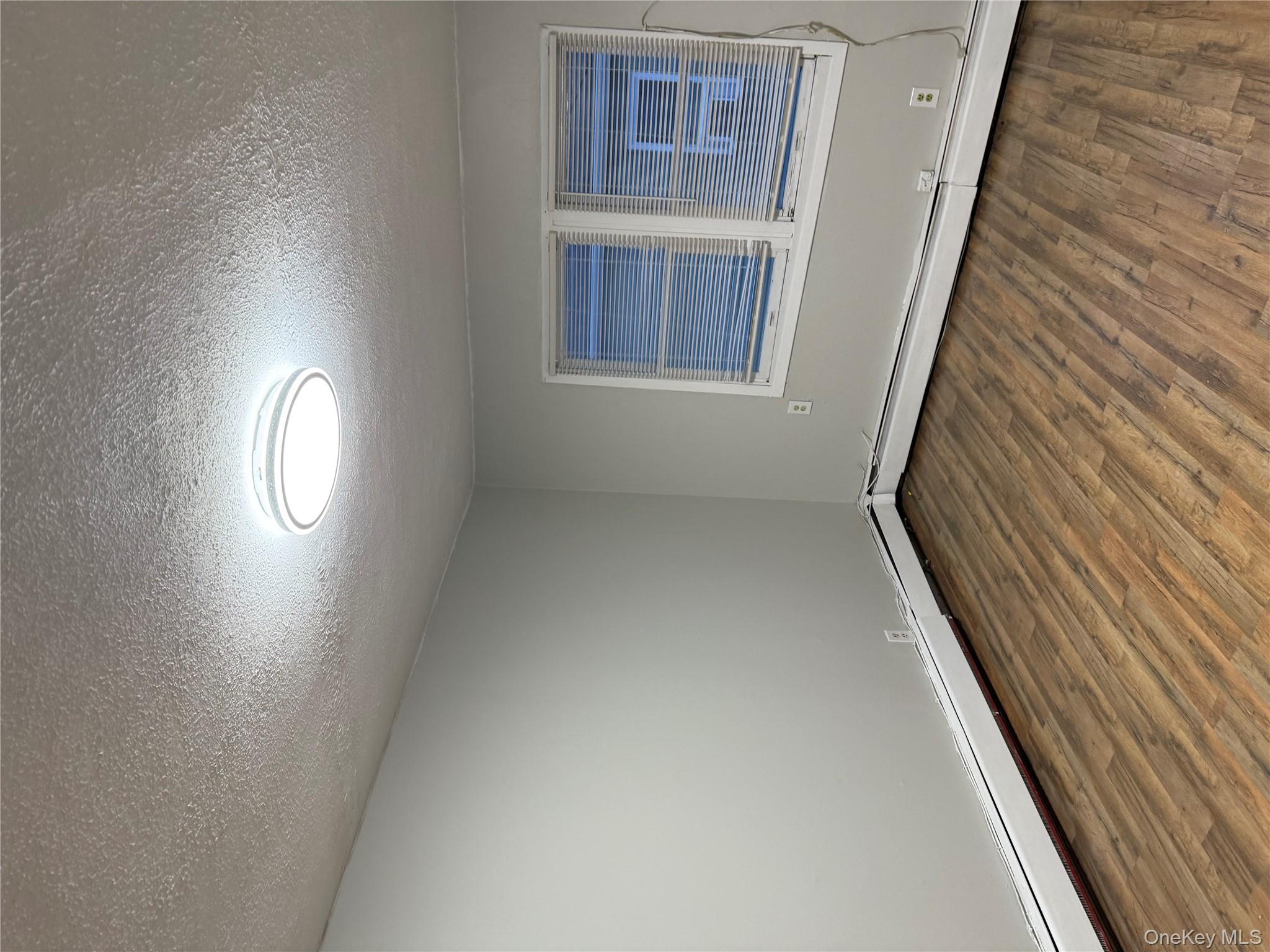 18 Leach Street Lynbrook, NY 11563 - Photo 2 of 17 a view of an empty room with wooden floor and a window