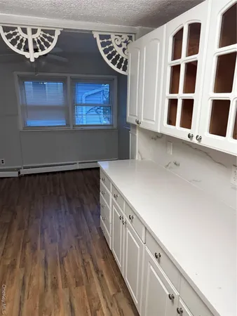 a view of an entryway with wooden floor