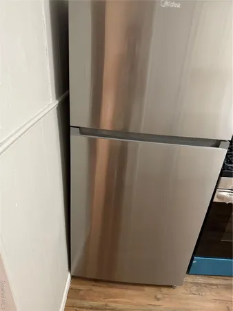 a view of walk in closet with wooden floor