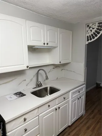a kitchen with stainless steel appliances granite countertop a sink a stove and cabinets