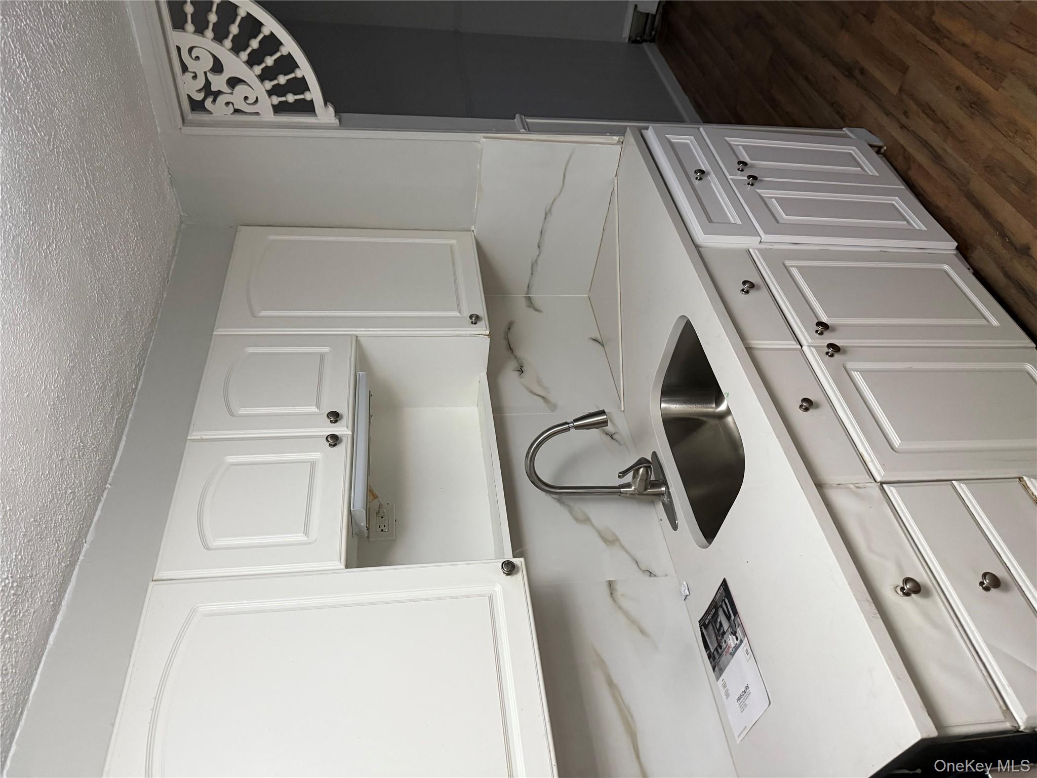 18 Leach Street Lynbrook, NY 11563 - Photo 7 of 17 a kitchen with stainless steel appliances granite countertop a sink a stove and cabinets