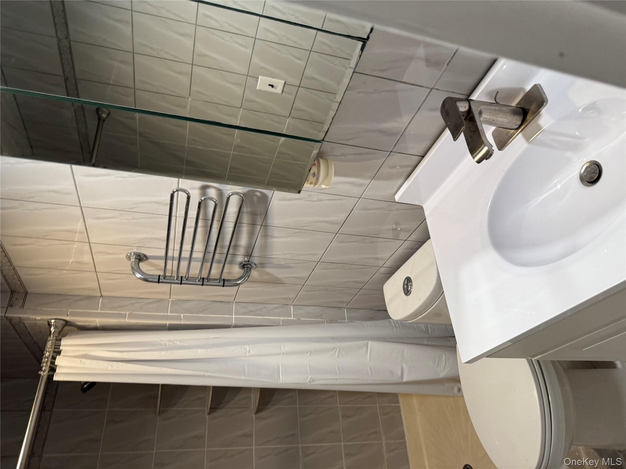 18 Leach Street Lynbrook, NY 11563 - Photo 9 of 17 a bathroom with a sink toilet and shower