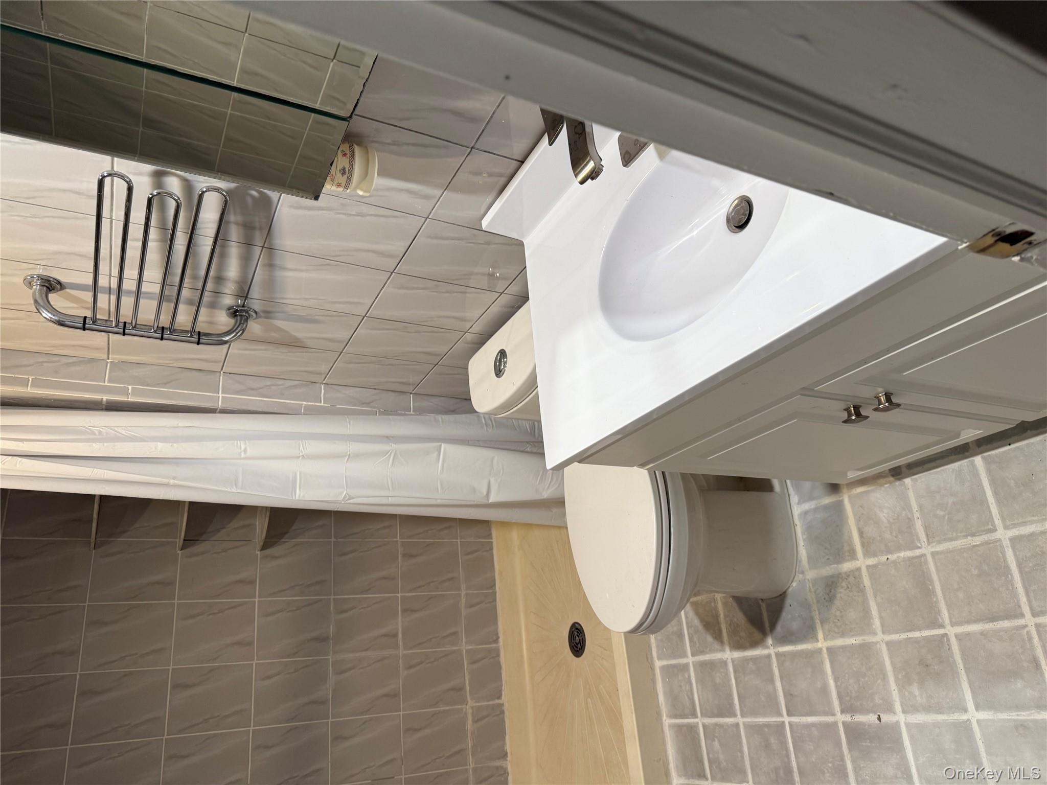 18 Leach Street Lynbrook, NY 11563 - Photo 10 of 17 a bathroom with a sink toilet and shower