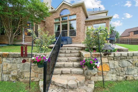 a front view of a house with a yard and potted plants