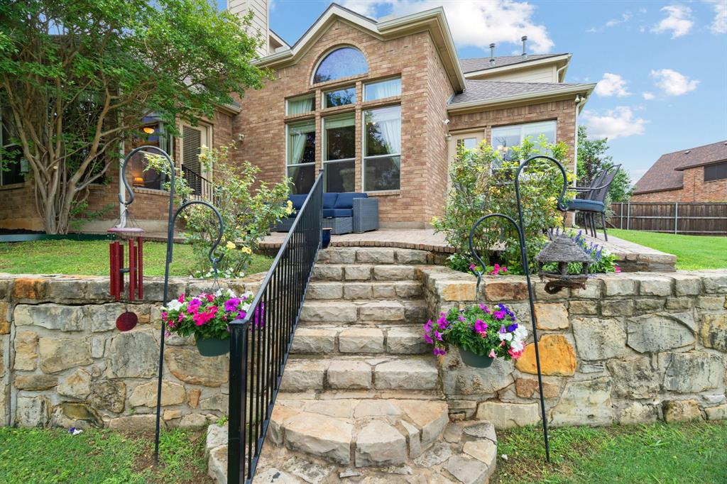2703 Pottery Trail Corinth, TX 76210 - Photo 34 of 40 a front view of a house with a yard and potted plants