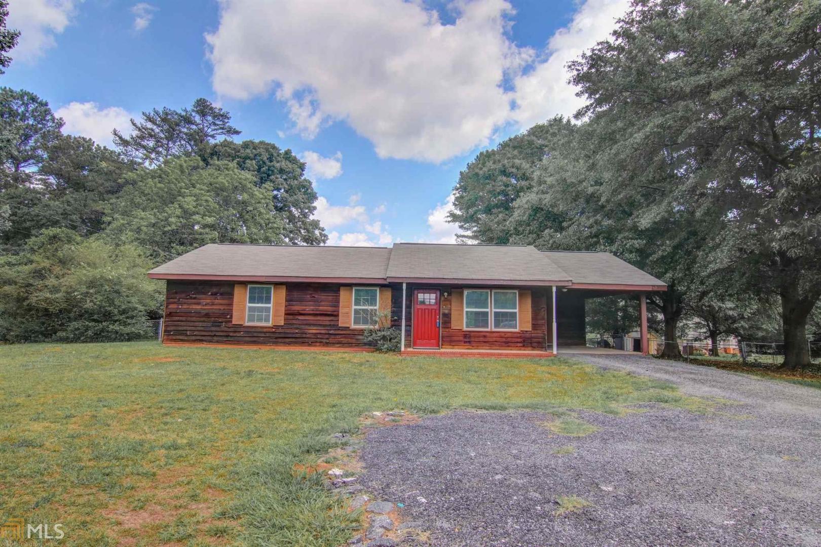 1220 Kirkland Road Covington, GA 30016 - Photo 1 of 1 a view of a house with a yard