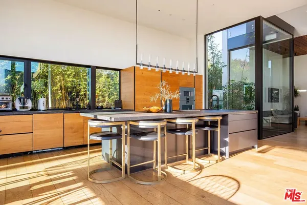 a view of a room with wooden floor and outdoor seating