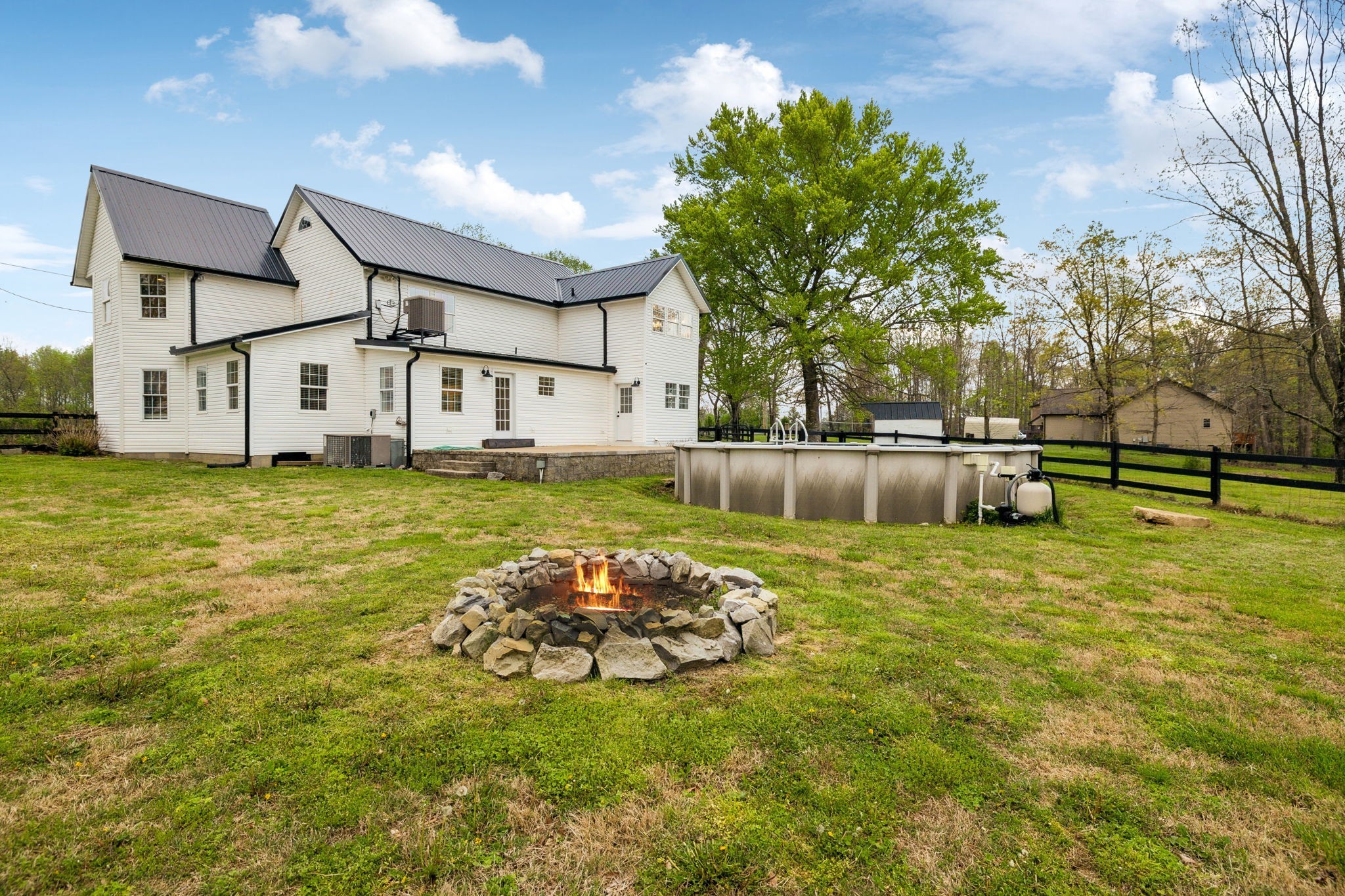 1054 Coker Ford Road Portland, TN 37148 - Photo 54 of 72 a white house with a big yard and large trees