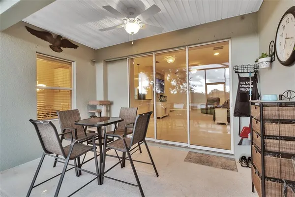 a living room with furniture a dining table and kitchen view