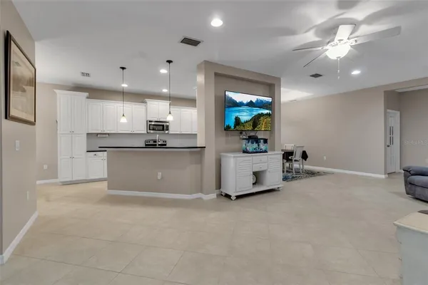 a large kitchen with stainless steel appliances granite countertop a stove a sink and a refrigerator