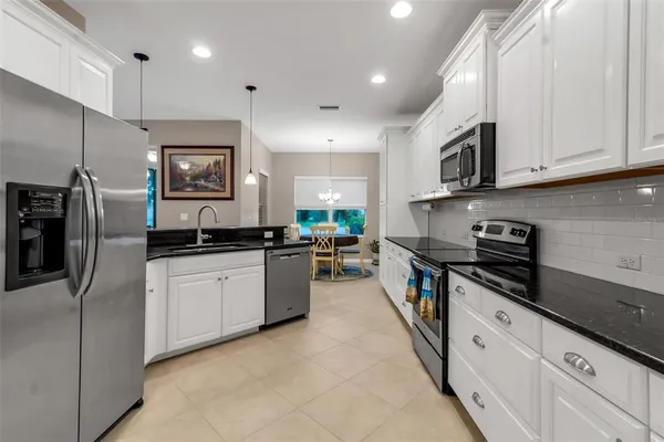a kitchen with stainless steel appliances granite countertop a sink and a stove