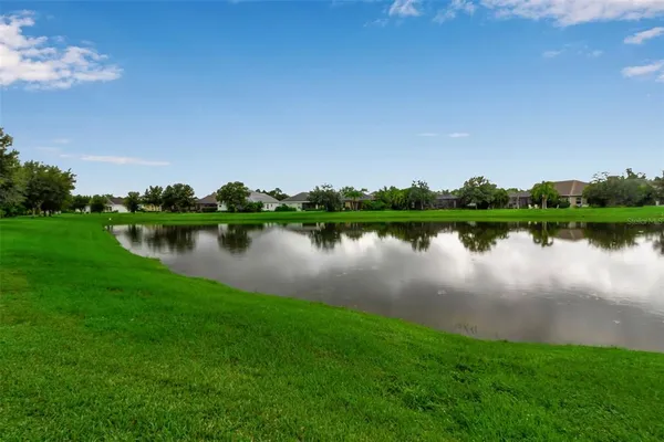 a view of a lake with houses in background