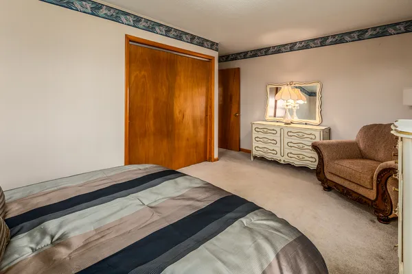 a bedroom with a bed and a couch