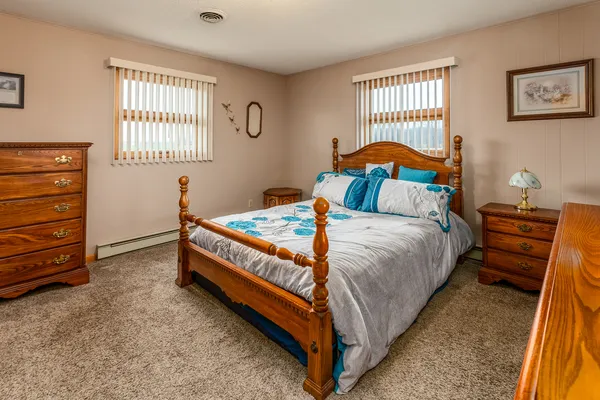 a bedroom with a bed and a window