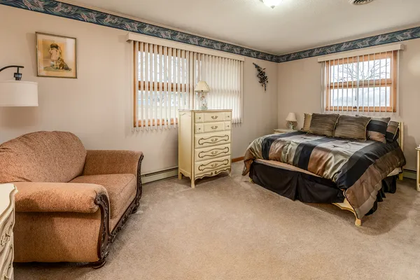 a spacious bedroom with a bed and a couch