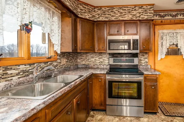 a kitchen with a stove sink and microwave
