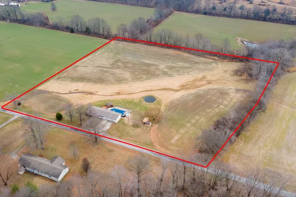 a view of a deck with a table and chairs under an umbrella with wooden floor